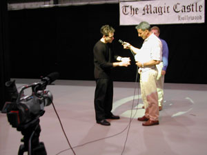 A Magic Castle magician shows off a card trick.